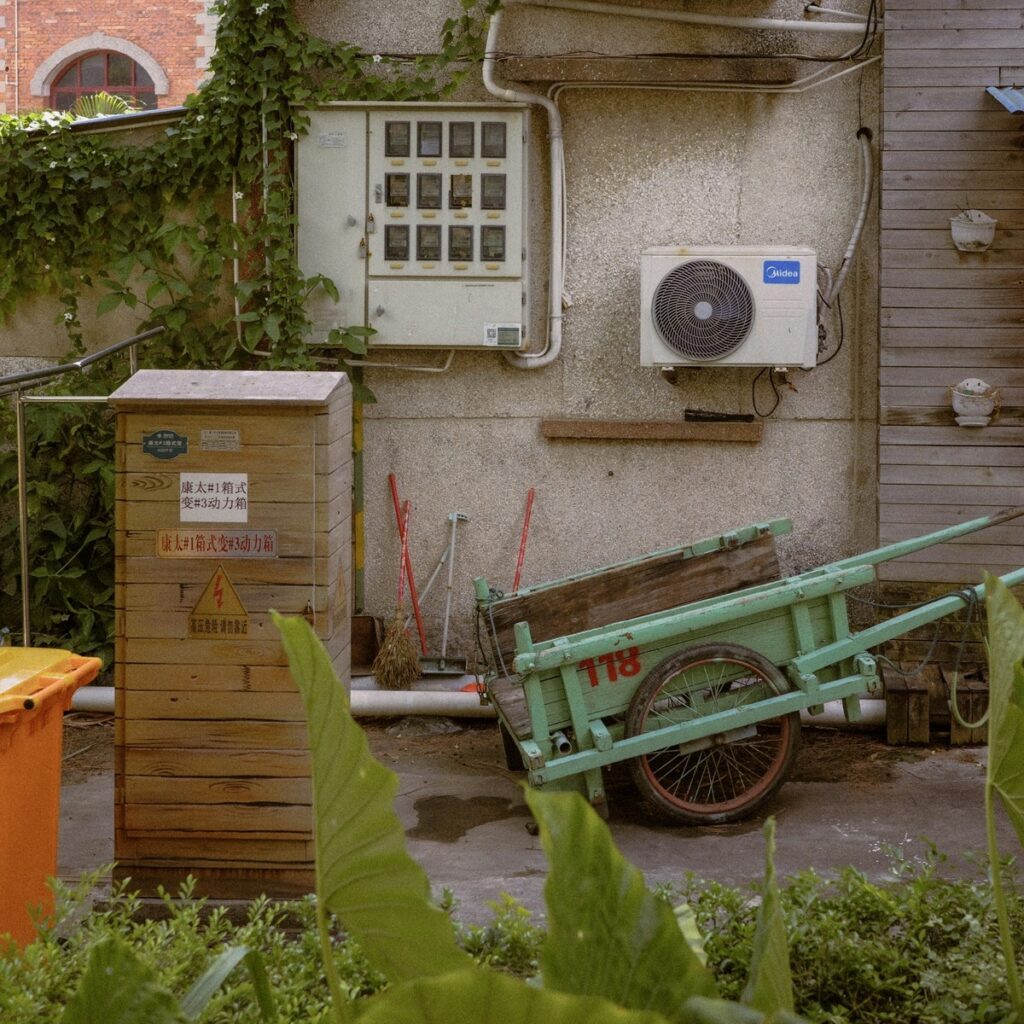 Discarded utility cart and outdoor cleanup materials beside a property, representing dumpster rental services near me.