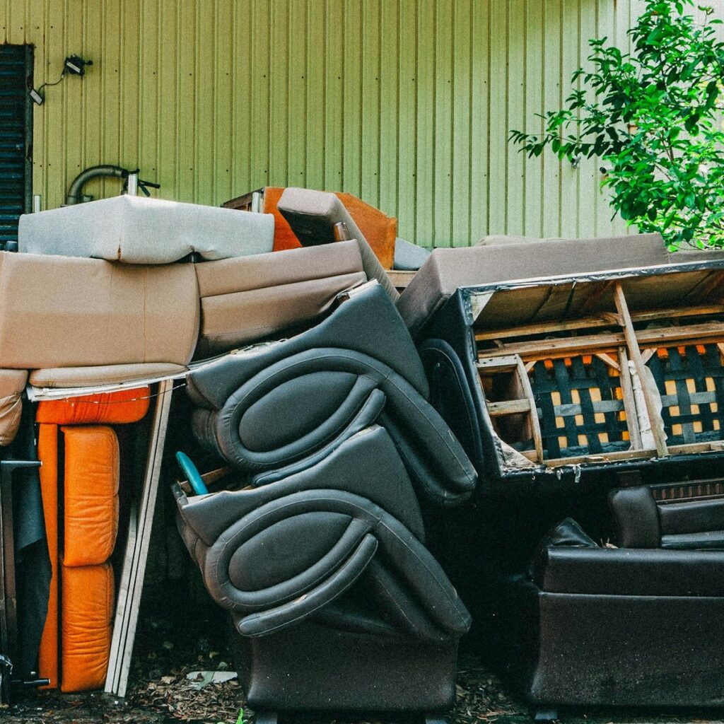 Discarded furniture and bulky household items prepared for dumpster disposal near me